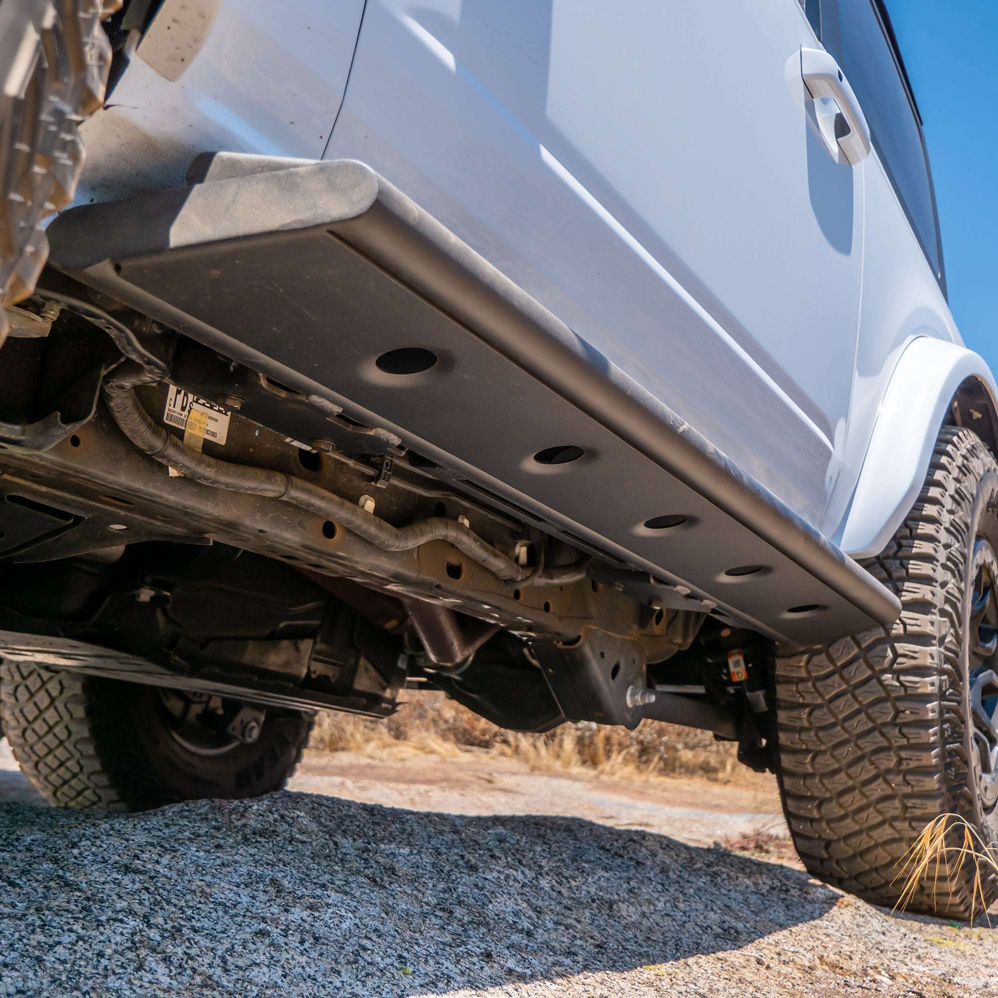 Underneath view of Ford Bronco showing step-slider and vehicle frame