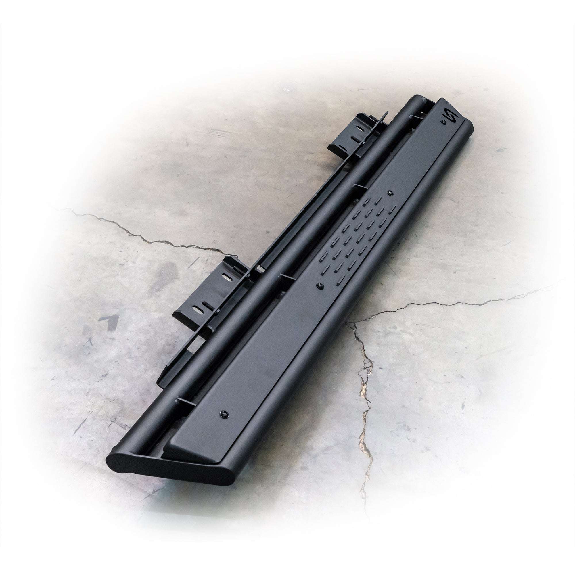 Close-up of black steel vehicle step with mounting brackets