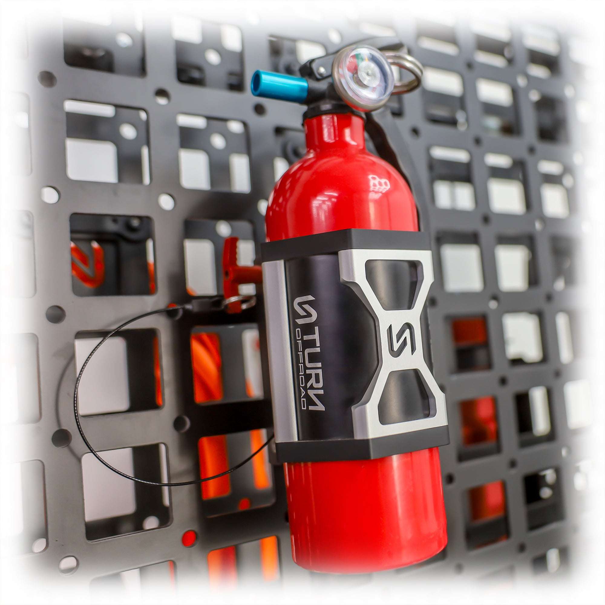 Fire extinguisher mounted on wall with quick release bracket