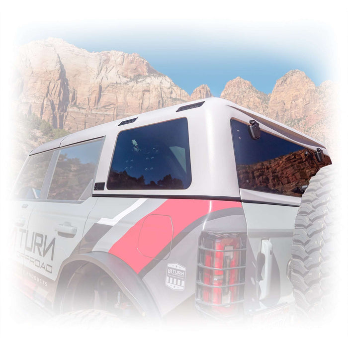 White off-road vehicle with hard top in desert landscape